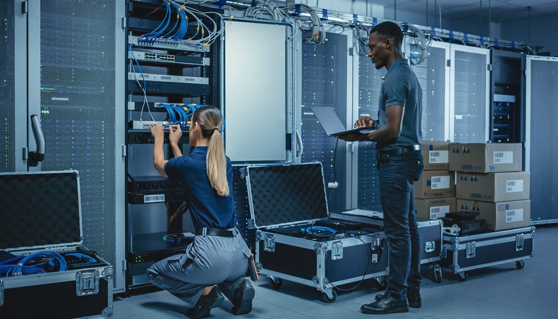 IT technicians deploying and cabling network hardware on-site